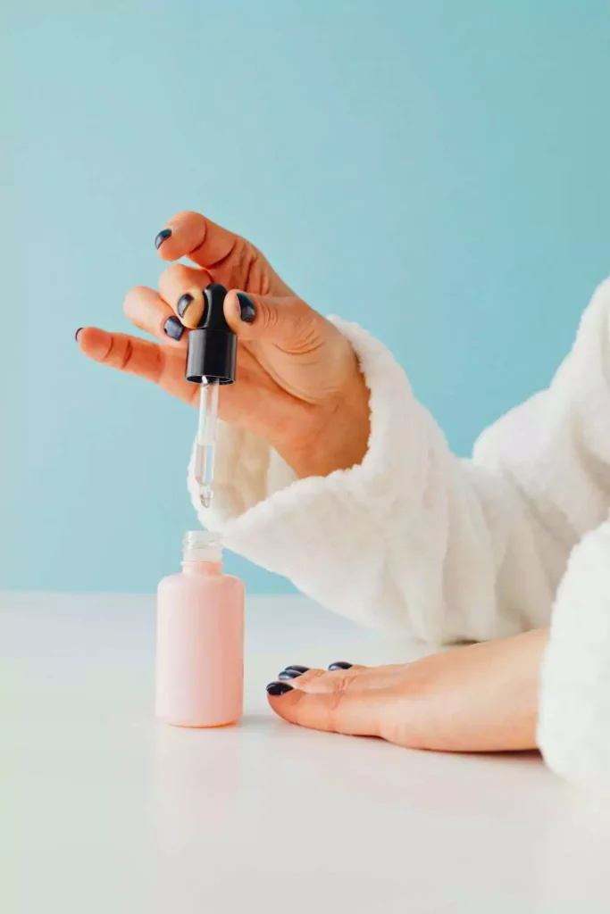 A girl soaking her nails in Olive oil
